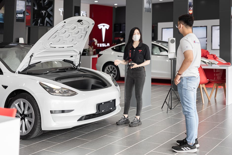 A family sitting inside a Tesla car, ready for a road trip